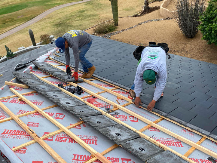 Vitruvion installation team laying solar roof tiles on a premium residential property