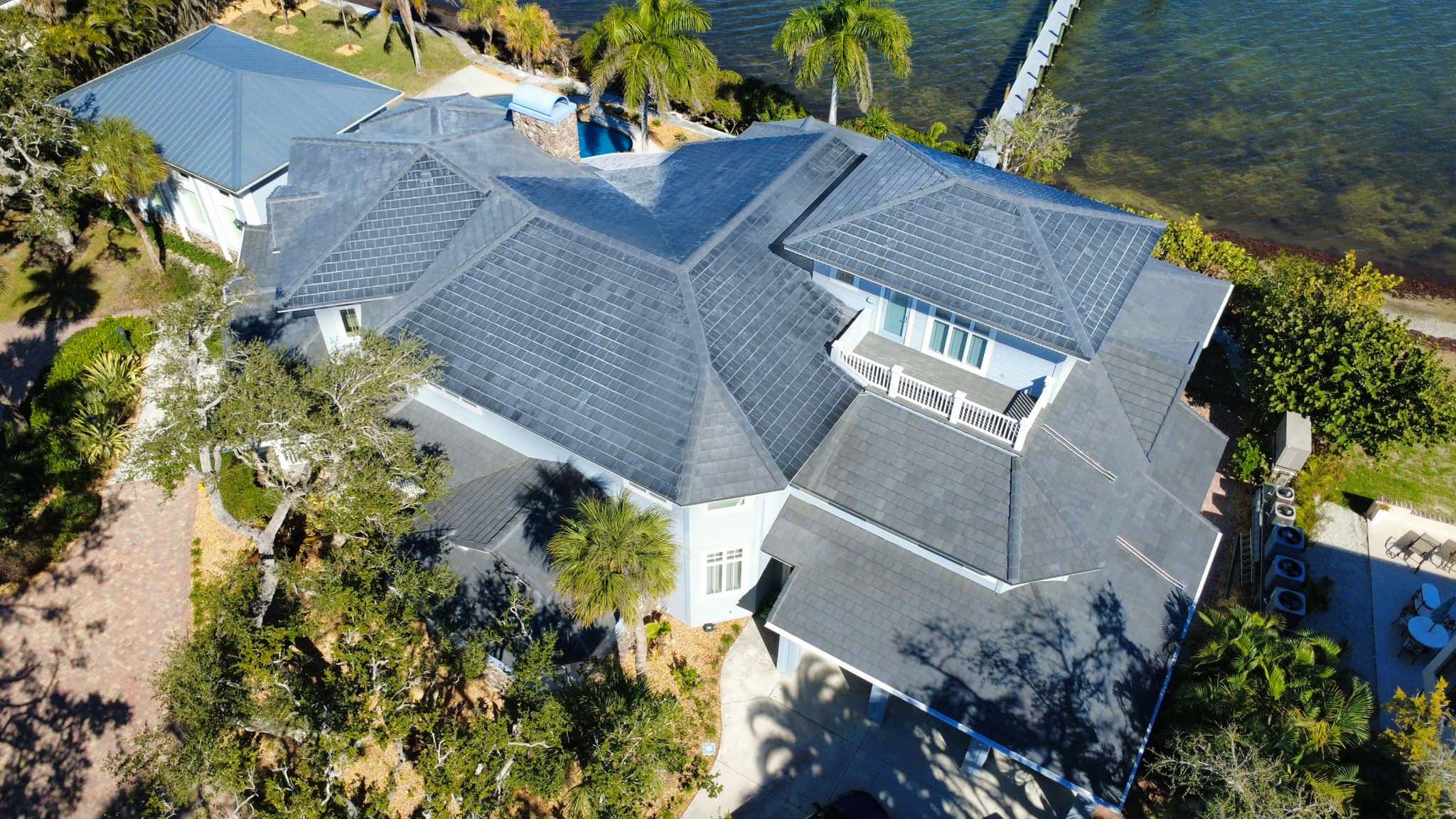 Voltaic integrated solar roof tile installation on estate residence showing complete architectural integration with zero visible solar indication