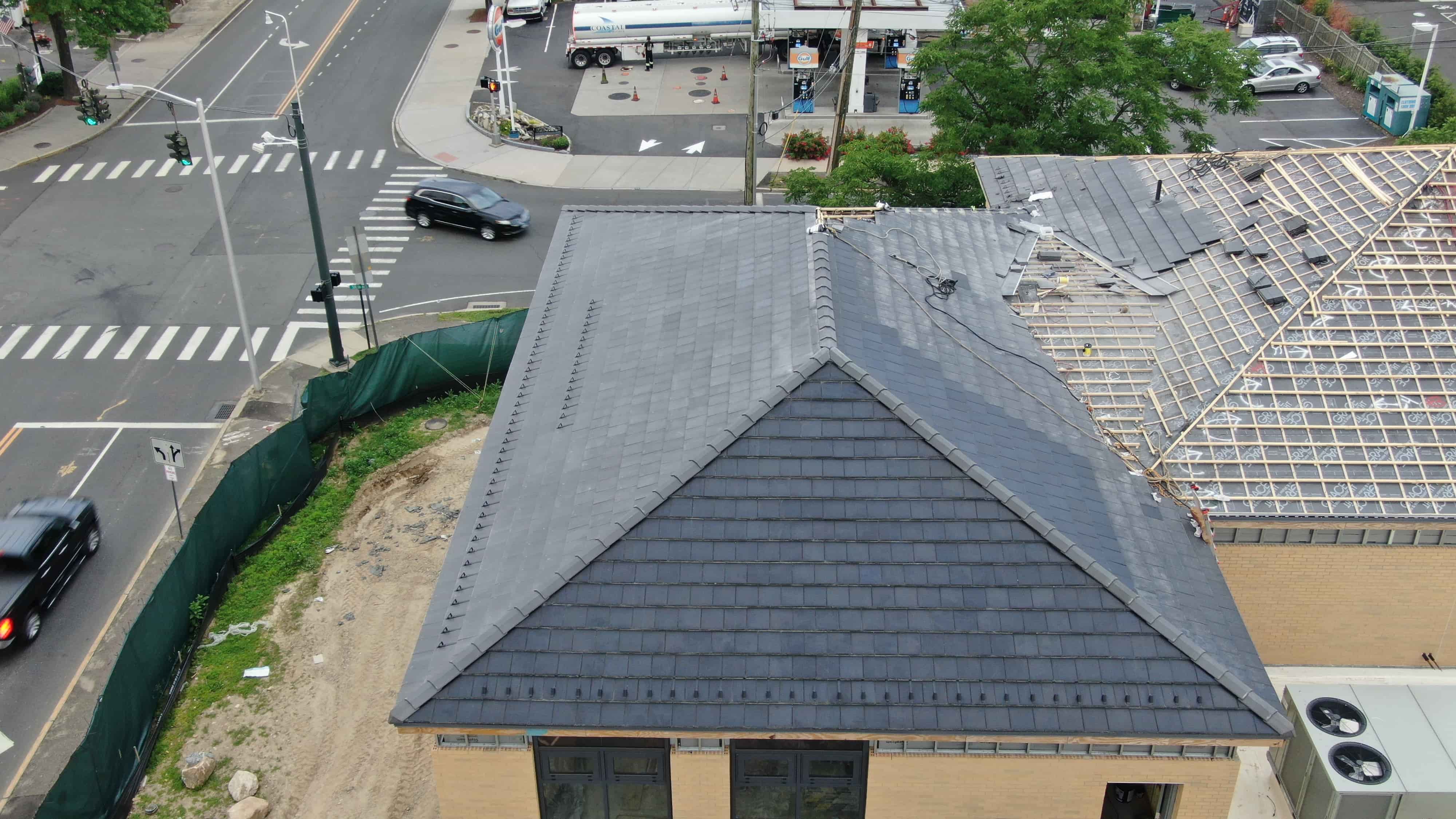 Voltaic concrete solar tiles being installed on building